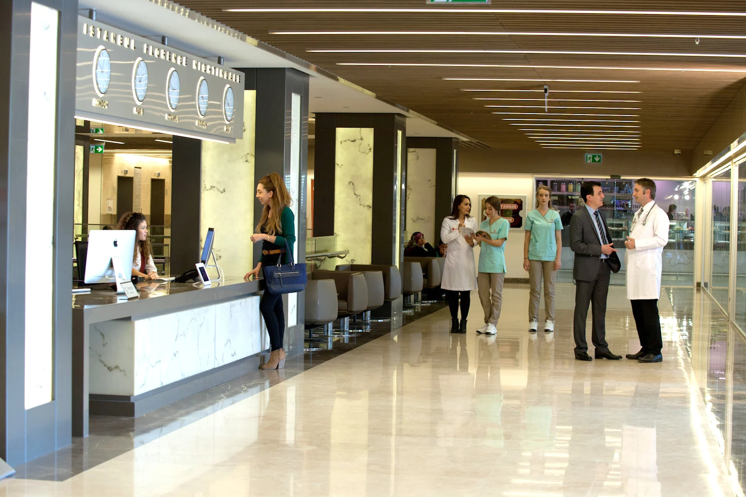Doctor and healthcare team welcoming visitors in the Florence hospital lobby